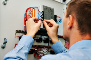 an electrician from Altech Electric working on a client's electrical system