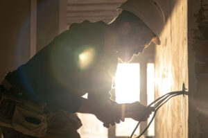 a licensed electrician at Altech Electric hard at work for a client