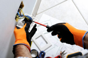 an Altech Electric electrician installing an outlet