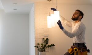 an Altech Electric electrician installing elegant lighting in the ceiling